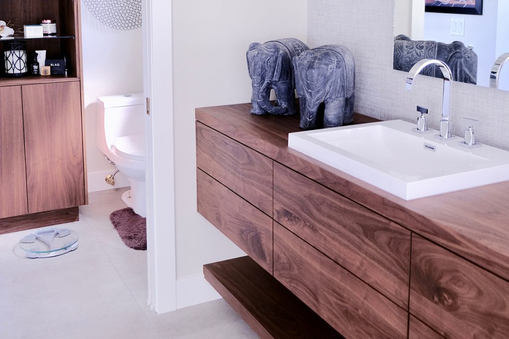 Cozy bathroom nook with artistic wall decor and soft towel accents.