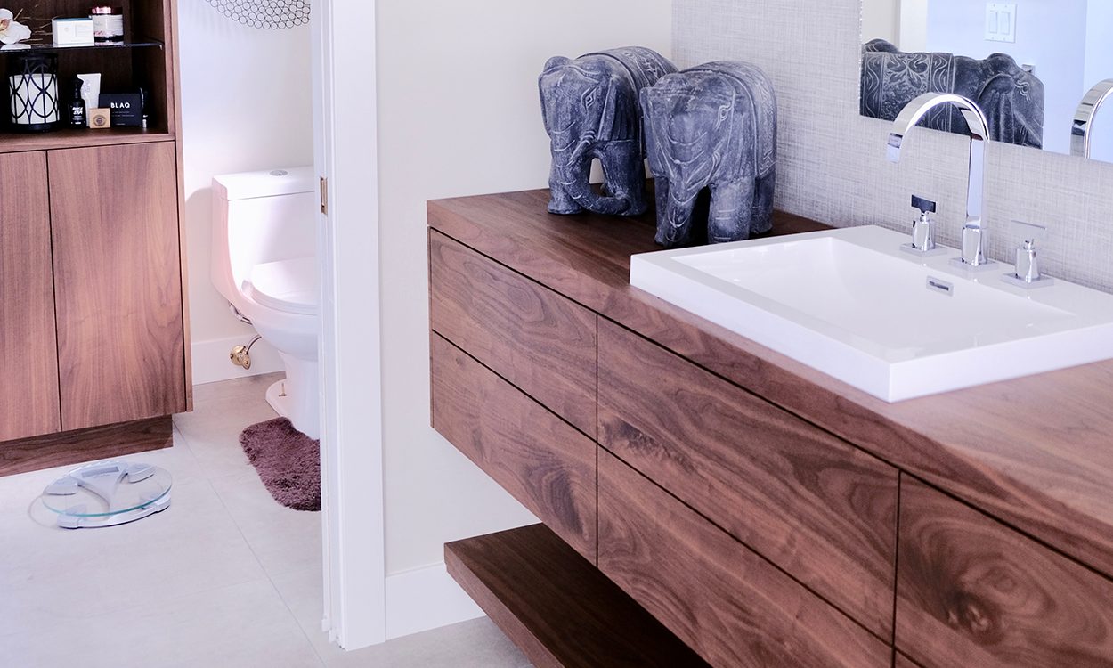 Cozy bathroom nook with artistic wall decor and soft towel accents.