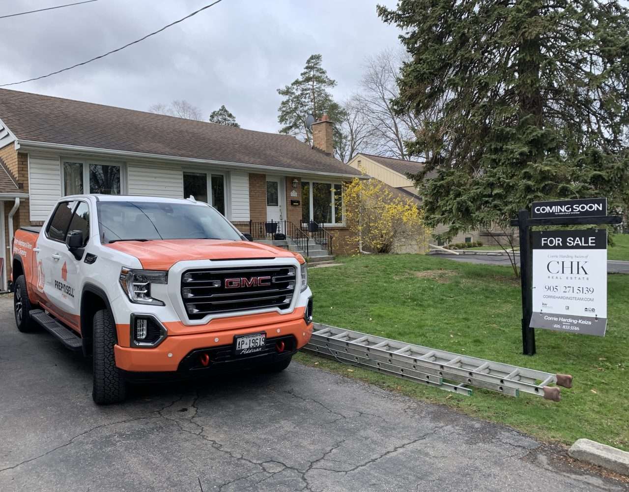 Image of a home sold sign in Calgary with our branded franchise truck in front.