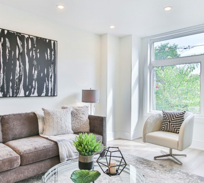Bright, modern living room with large windows, natural light, and spring-inspired decor.