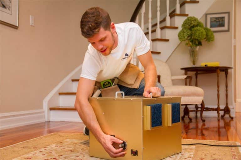 Technician setting up deodorizing equipment in Abbotsford