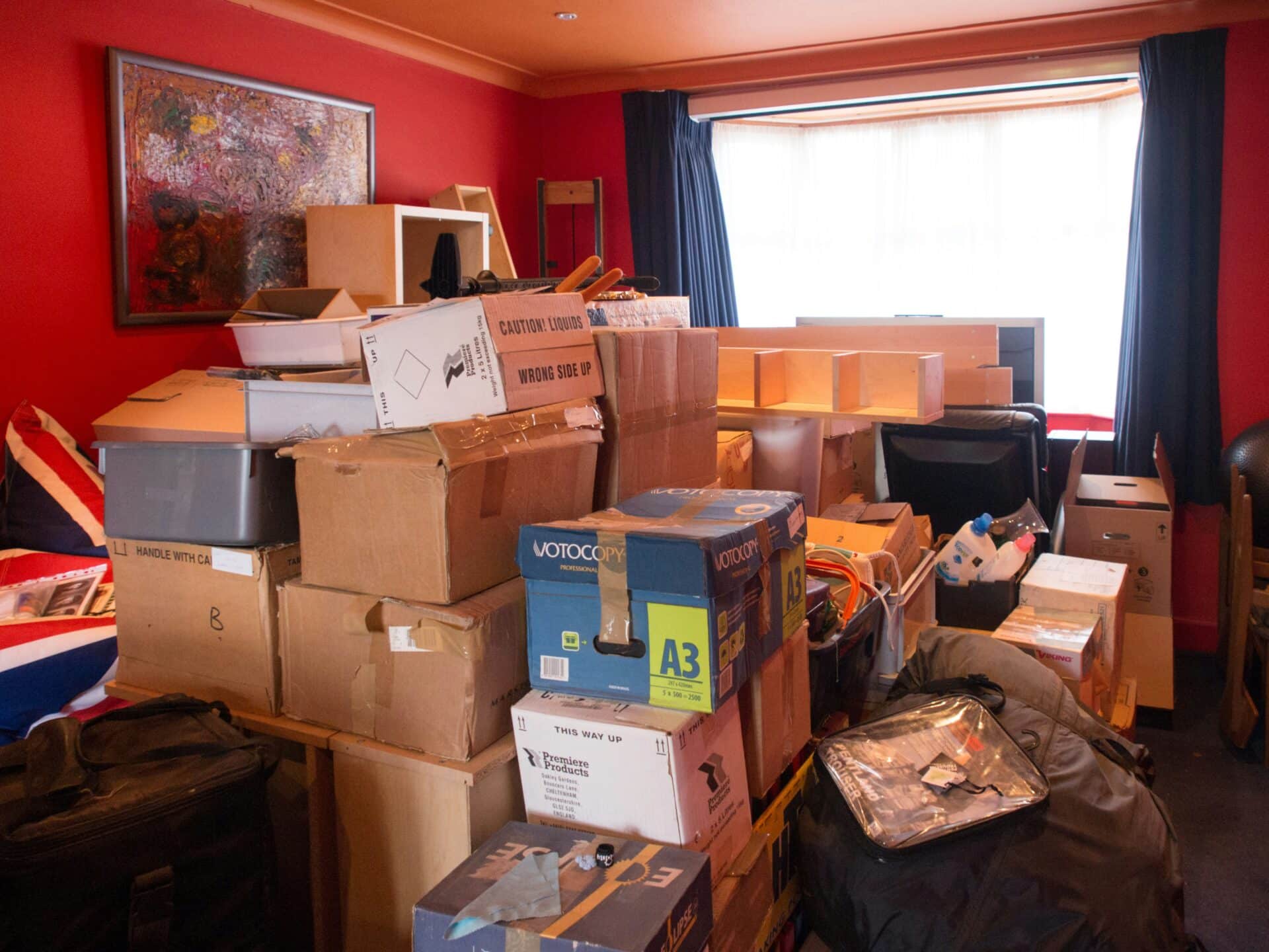 Cardboard box filled with clothes labelled for donation