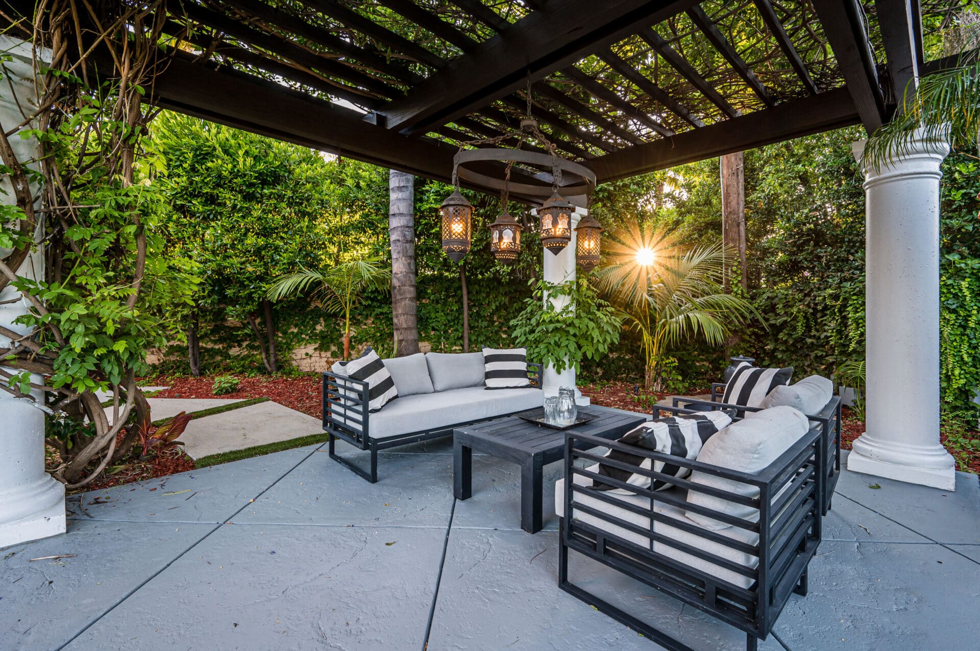 Modern patio with white couches staged for fall