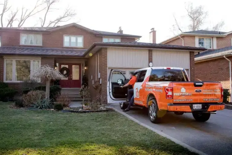 Prep’n Sell home makeover specialist stepping out of branded orange truck in front of a house
