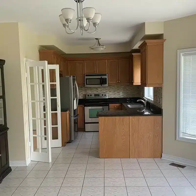Kitchen before — dated cabinets and flooring
