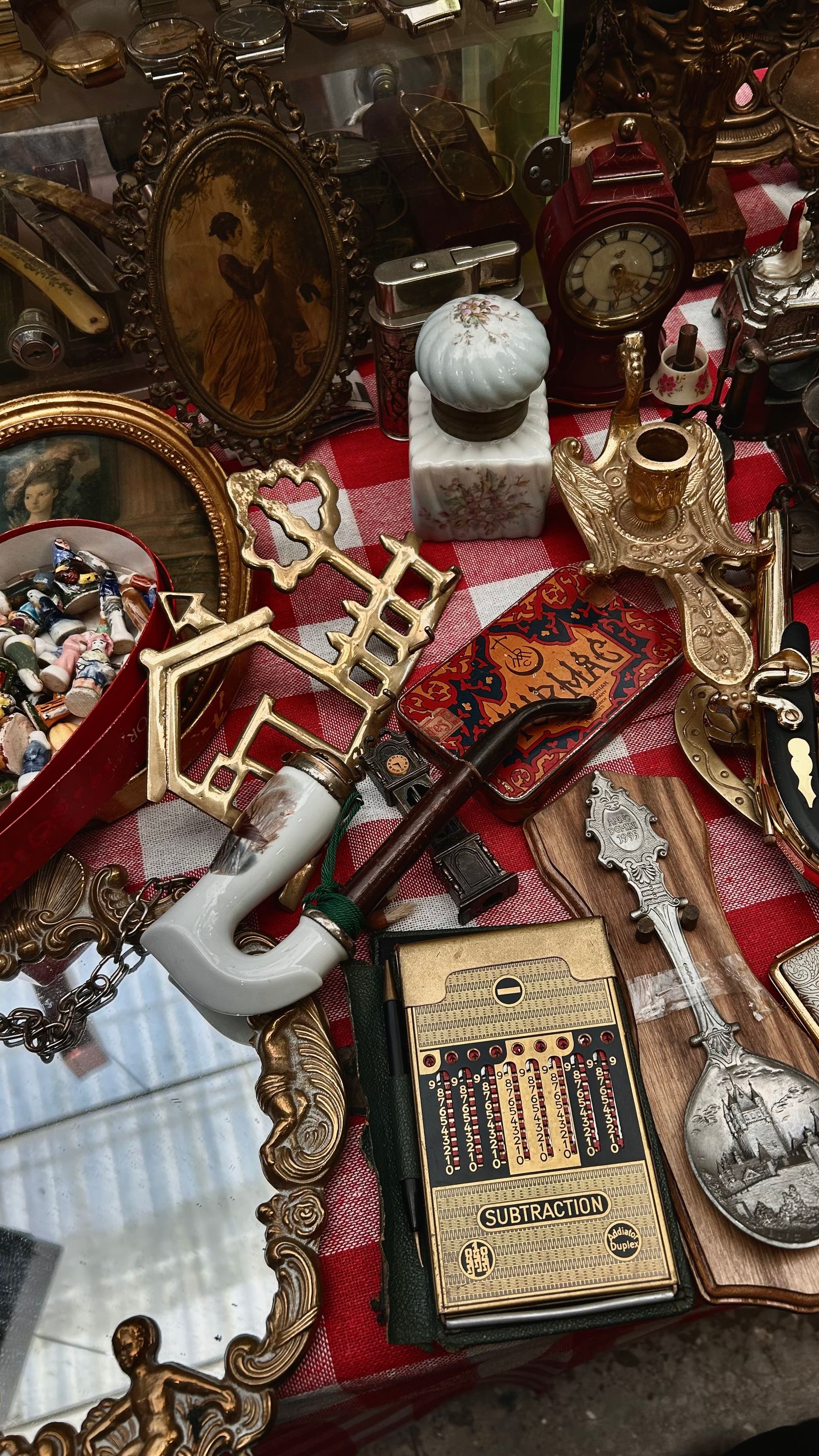 Antiques and collectibles laid out and catalogued before an online auction